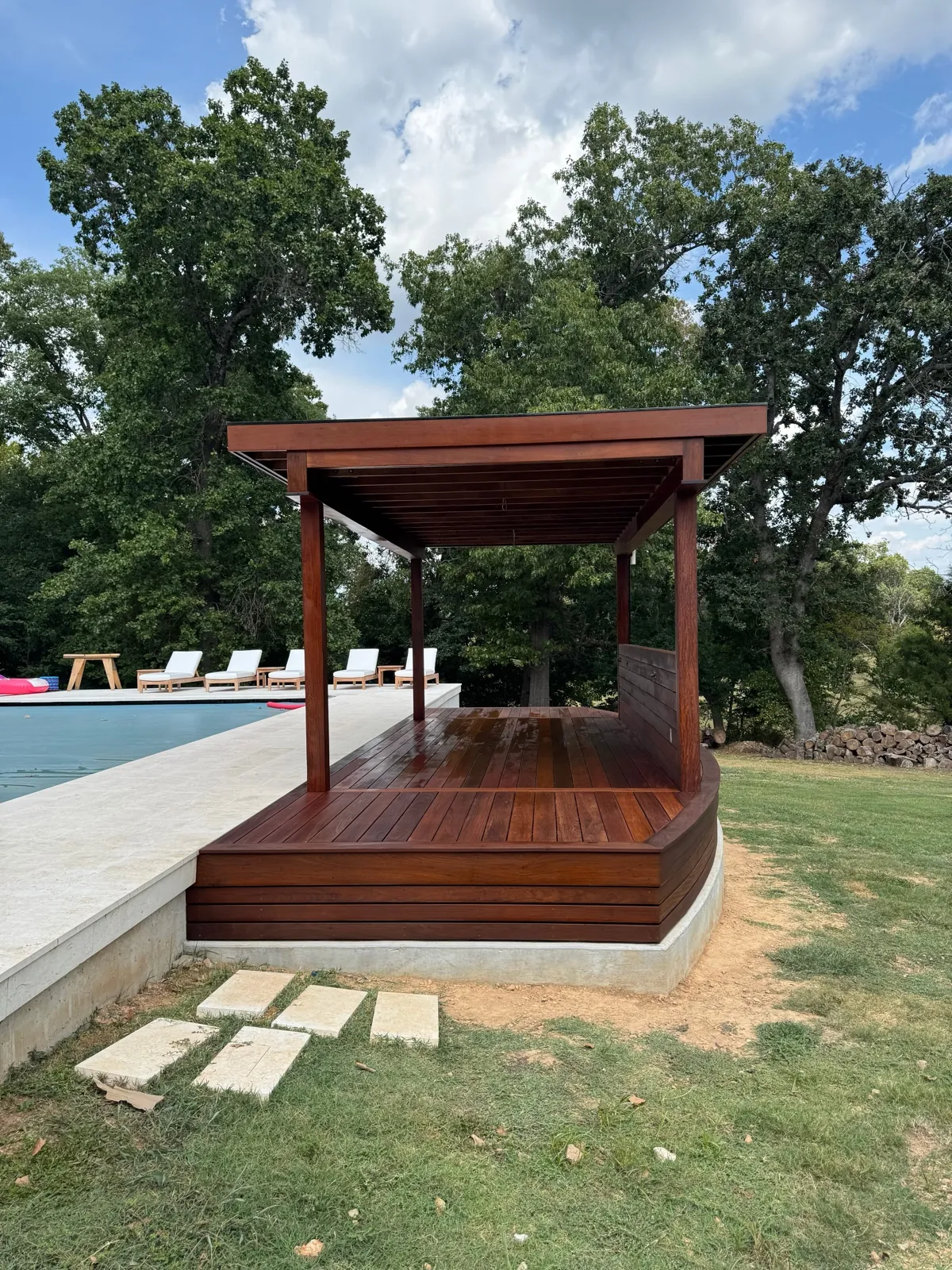 Finished ipe pergola pavilion with seating by the pool
