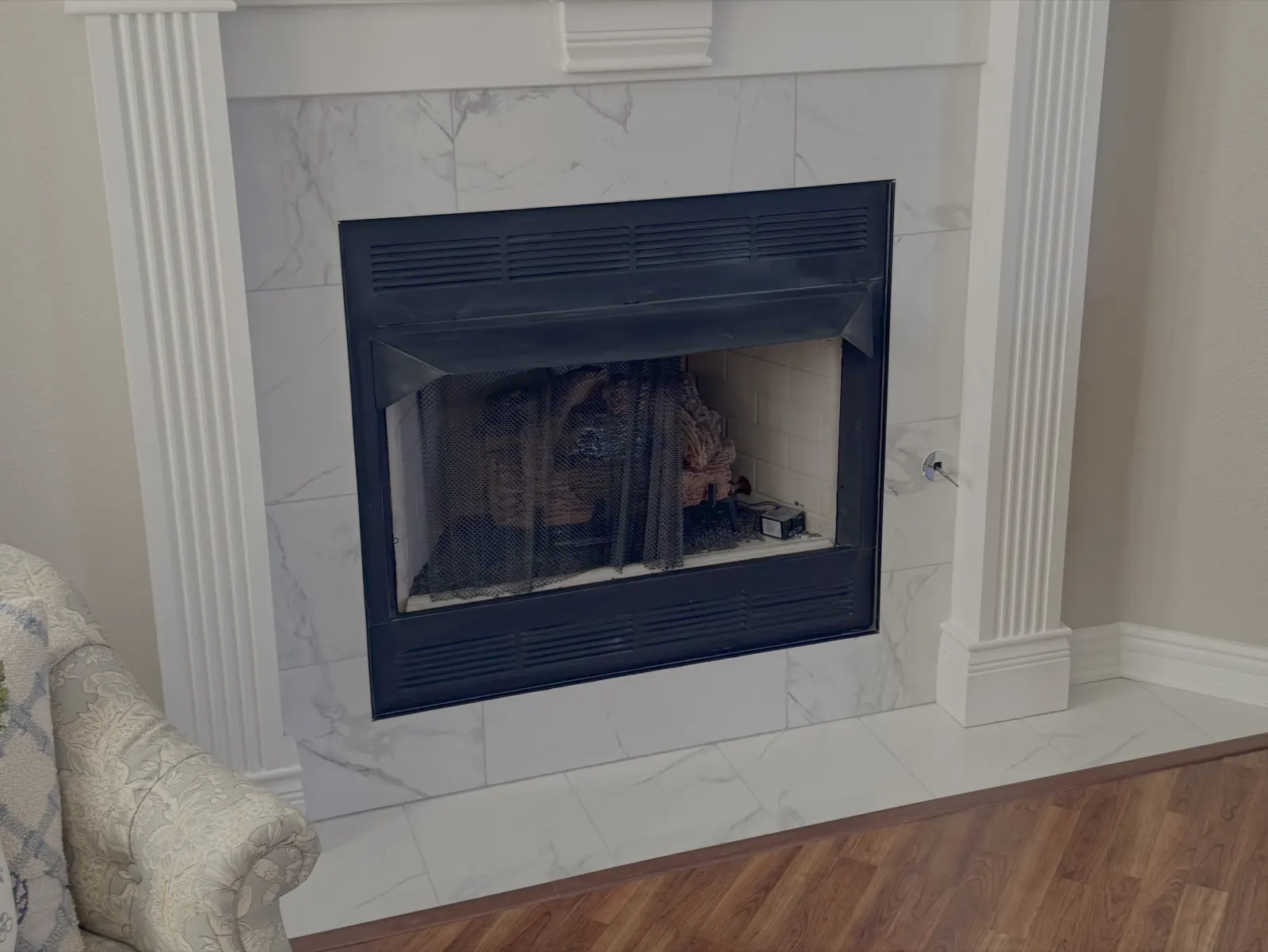 Fireplace surround with marble look tile and white mantel