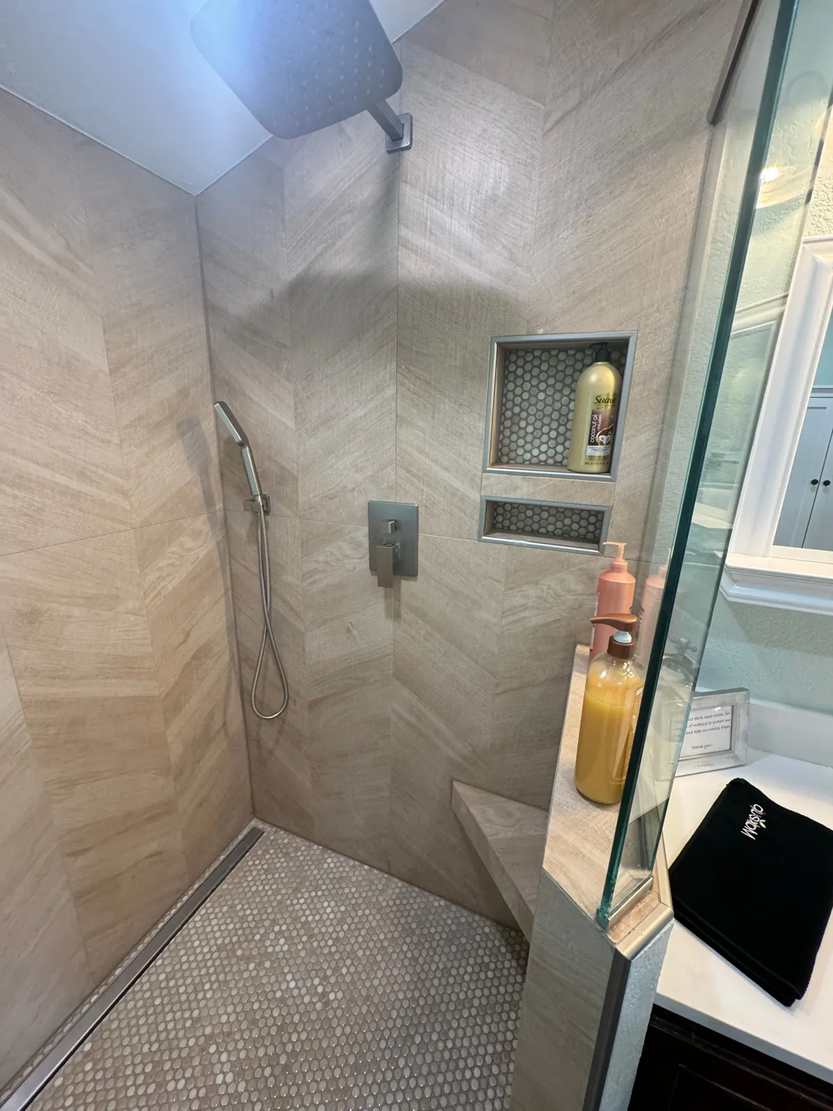Herringbone tile shower with niche shelving